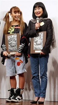 Miyuki Hatoyama, right, wife of Japanese Prime Minister Yuko Hatoyama, speaks after being awarded the Japan Jeans Association prize during an awarding ceremony of the 26th Best Jeanist Awards in Tokyo, Japan, Monday, Oct. 19, 2009.