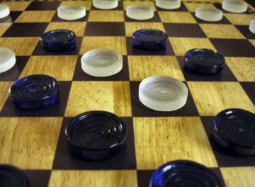 A game of checkers gets more complicated with each move.