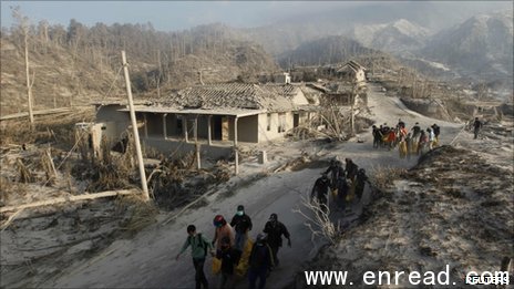 Rescuers carry victims away in a landscape turned to white by dust