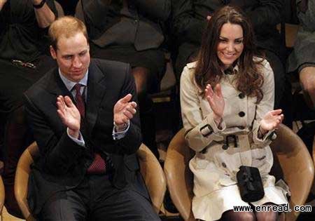 Britain's Prince William and his fiancee, Kate Middleton, applaud as they watch a play at the Youth Action Northern Ireland Centre, in Belfast, Northern Ireland March 8, 2011.