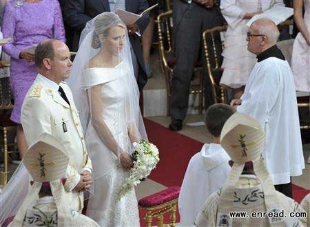Monaco's Prince Albert II (L) and Princess Charlene stand at the altar in front of a priest during their religious wedding ceremony at the Palace in Monaco July 2, 2011.