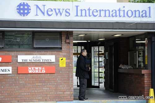 A security guard stands at the entrance to News International offices in Wapping, London, July 7, 2011.