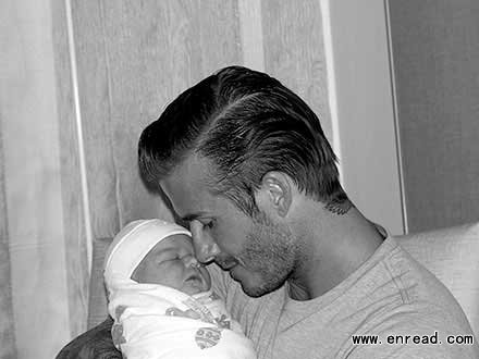 Daddy's little girl: Victoria Beckham has posted the first picture of husband David with their new daughter Harper Seven