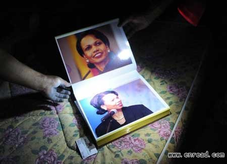 Rebels show off the album featuring former Secretary of State Condoleezza Rice, found in Colonel Gaddafi's residence, Bab Al Aziziya