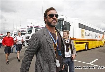 Former soccer player Eric Cantona walks in the paddock ahead of the British F1 Grand Prix at Silverstone, central England, June 21, 2009.