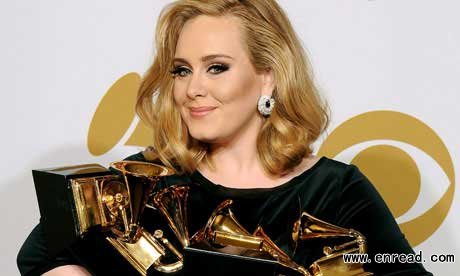 Adele poses backstage with her six awards at the 54th annual Grammy Awards on Sunday, Feb. 12, 2012 in Los Angeles.