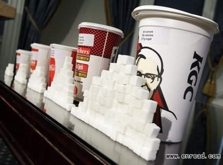 Various size cups and sugar cubes are displayed at a news conference at New York's City Hall, Thursday, May 31, 2012.