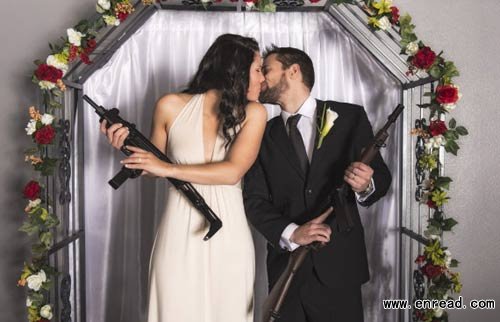 A happy couple pose proudly with their guns