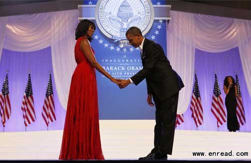 US President Barack Obama bows to First Lady Michelle Obama at the Inaugural ball in Washington, January 21, 2013.