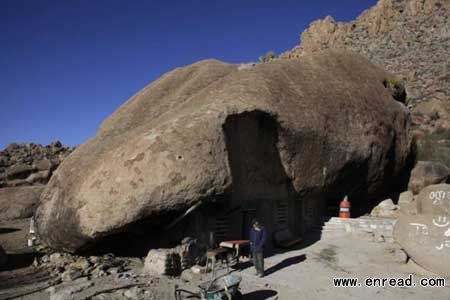 A hut wedged below a 130-foot boulder in Coahulla, Mexico has been home for the past 30 years.