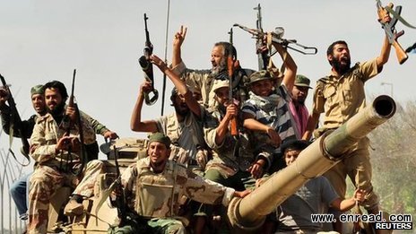 Rebel fighters celebrate the fall of Sirte two years ago. Lawlessness has been <a href=