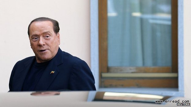 Berlusconi glanced at journalists but gave no statement as he arrived to start his community service