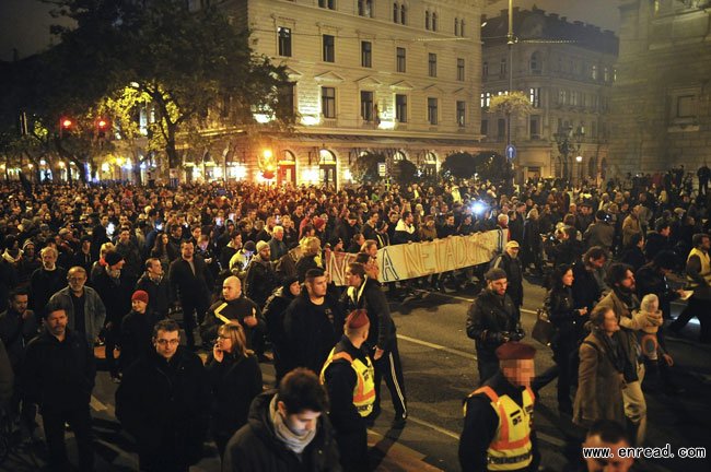 Thousands of demonstrators march through the streets of Budapest as they protest against an Internet tax planned to be introduced by the Hungarian government, in the Hungarian capital, Sunday, Oct. 26, 2014.