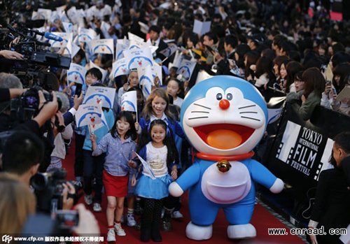 Manga character Doraemon walks on the red carpet with children from around the world during the opening event of Tokyo International Film Festival to promote the movie 