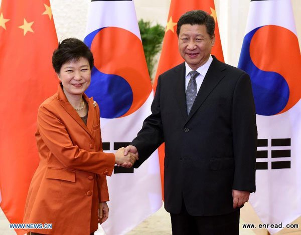 Chinese President Xi Jinping and his ROK counterpart Park Geun- hye shake hands during the APEC meetings in Beijing on Nov 10,2014.
