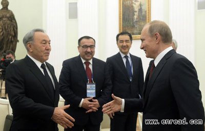 Russian President Vladimir Putin (R) welcomes his Kazakh counterpart Nursultan Nazarbayev during a meeting at the Kremlin in Moscow, December 22, 2014.