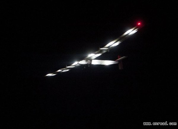 With the familiar line of LEDs on the front, Solar Impulse 2, the world\s only solar powered aircraft, flies over the Mandalay International Airport in Myanmar on March 30, 2015.