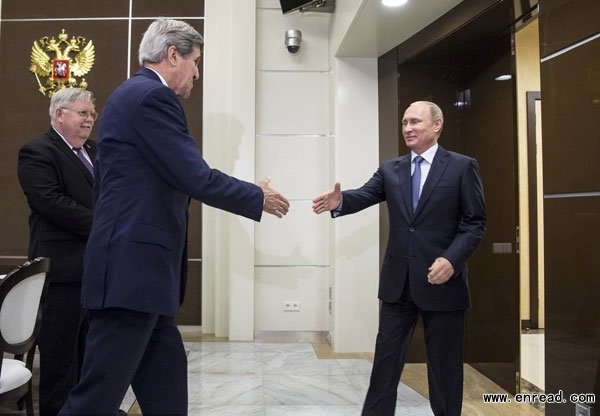 U.S. Secretary of State John Kerry (C) shakes hands with Russian President Vladimir Putin as U.S. Ambassador