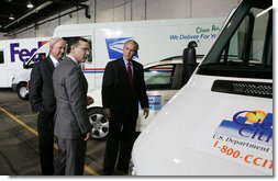 President George W. Bush and Secretary of Energy Sam Bodman listen to Mark Chernoby as the Vice President of Advance Vehicle Engineering at DaimlerChrysler describes the FedEx Pilot Program Plug-in Hybrid Sprinter during the President's visit Tuesday, March 27, 2007, to the U.S. Postal Service Vehicle Maintenance Facility in Washington, D.C. White House photo by Joyce Boghosian